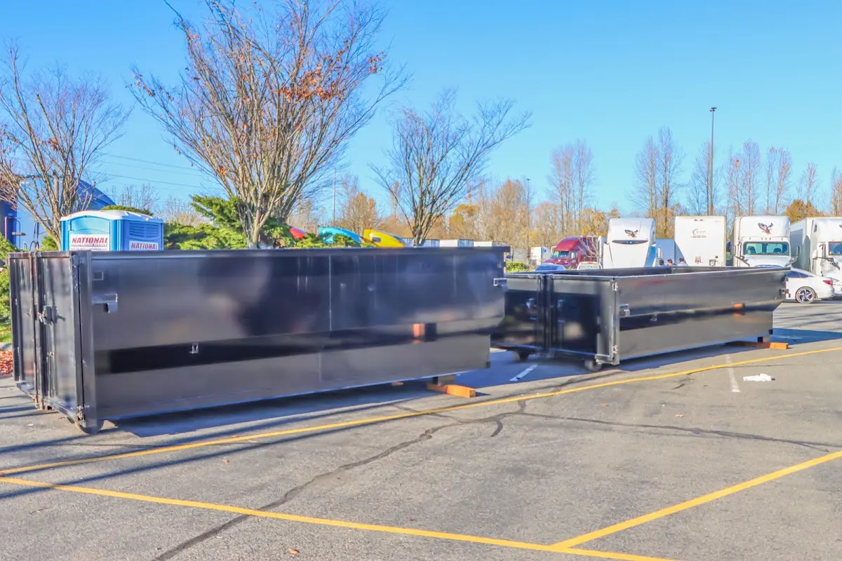 Professional dumpster rental service with roll-off container on residential driveway in Westlake Village